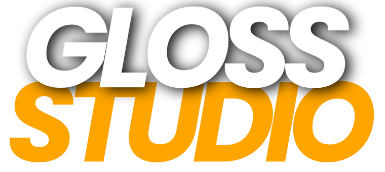 The logo for Gloss Studio, featuring the text 'GLOSS STUDIO' in bold sans-serif lettering. The top word 'GLOSS' is in white with a dark gray drop shadow, and the bottom word 'STUDIO' is in a vibrant orange-yellow color with a matching drop shadow, set against a plain white background.
